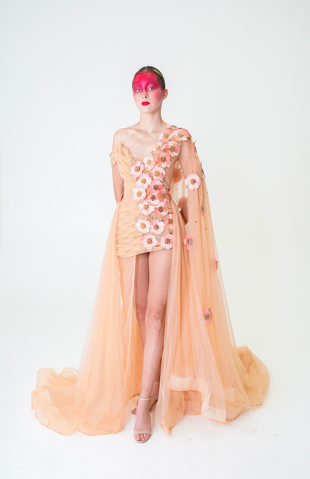 NUDE MINI DRESS WITH ONE SHOULDER CAPE AND CASCADING FLORAL APPLIQUE DETAILS